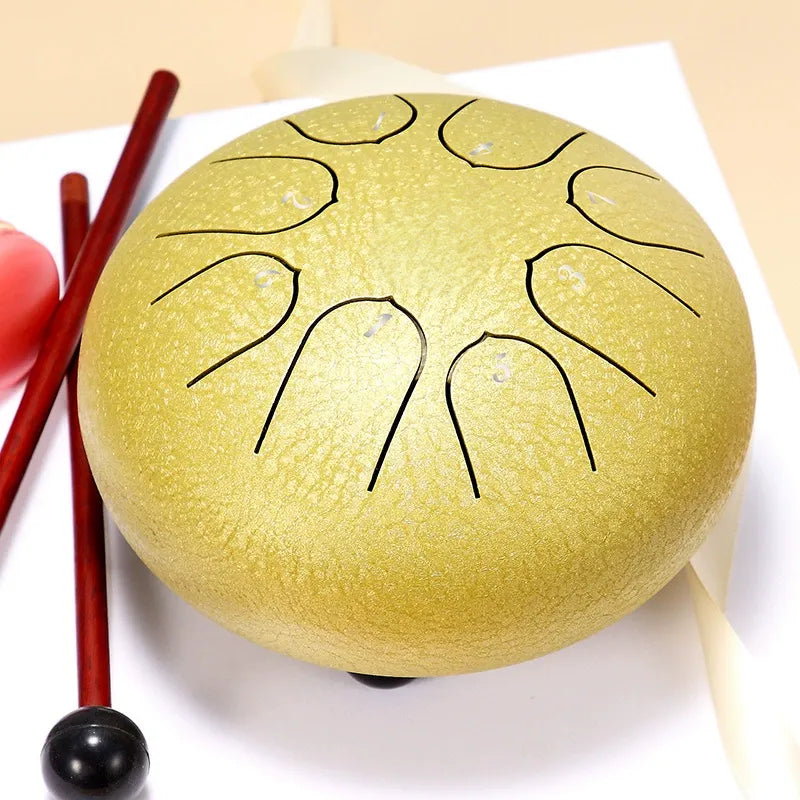 An elegant, champagne gold 6-inch 8-note steel tongue drum, a high-quality handpan for sound therapy.