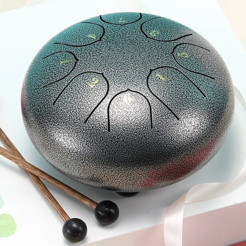 A shining, moonlight silver 6-inch 8-note steel tongue drum, a sleek meditation musical instrument.