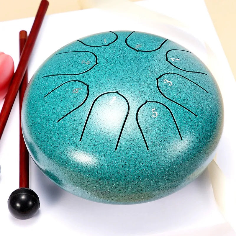 A striking, peacock teal 6-inch 8-note steel tongue drum, a vibrant and fun percussion instrument.