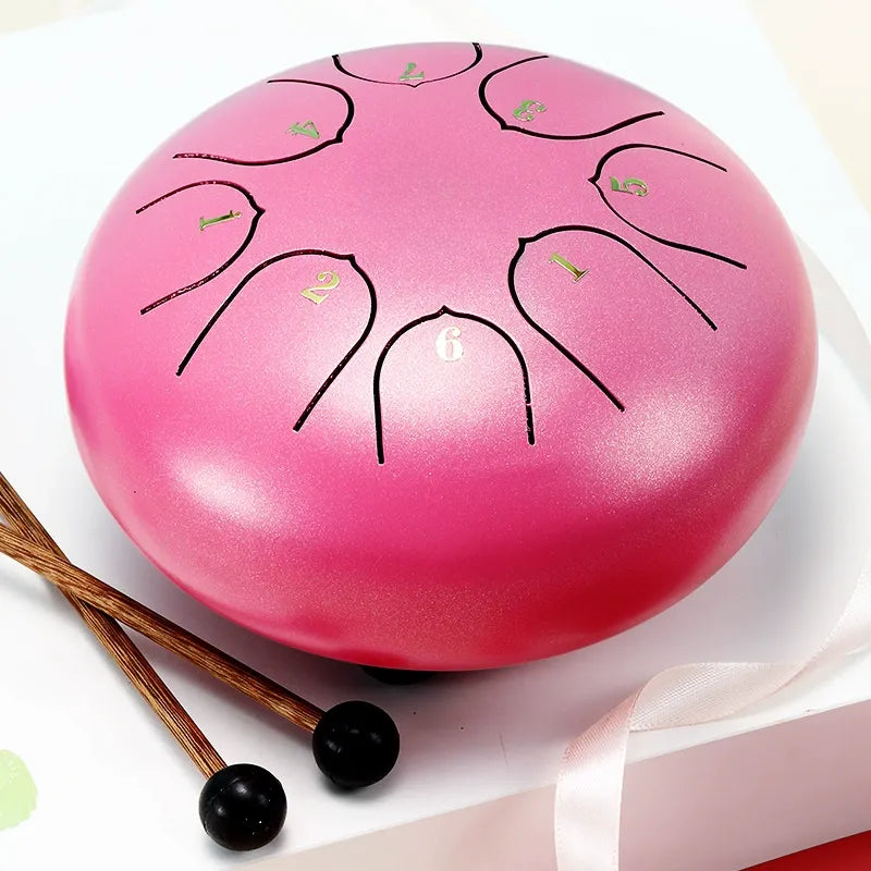 A delicate, sakura pink 6-inch 8-note steel tongue drum, perfect for new learners and children.