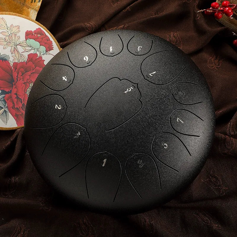 A sleek, obsidian black MoralGain 12-inch 13-note D-Key steel tongue drum, ideal for creating calming and meditative tones.