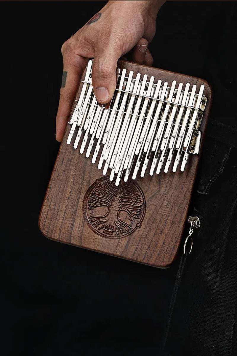 A close-up of a professional musician's hands holding the MoralGain® Legacy kalimba, emphasizing its exquisite craftsmanship and comfortable playability.