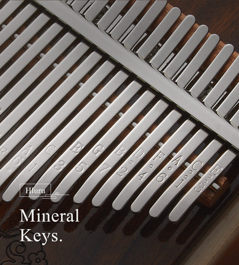 A detail view of the MoralGain® Master kalimba's 21 keys, showing the clear note engravings and the texture of the high-quality tines.