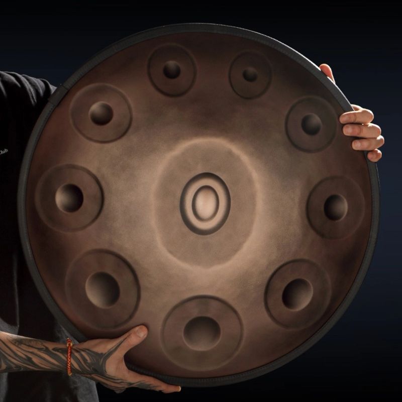 A person playing a MoralGain® Master handpan in a serene outdoor setting, emphasizing the instrument's use for meditation and relaxation.