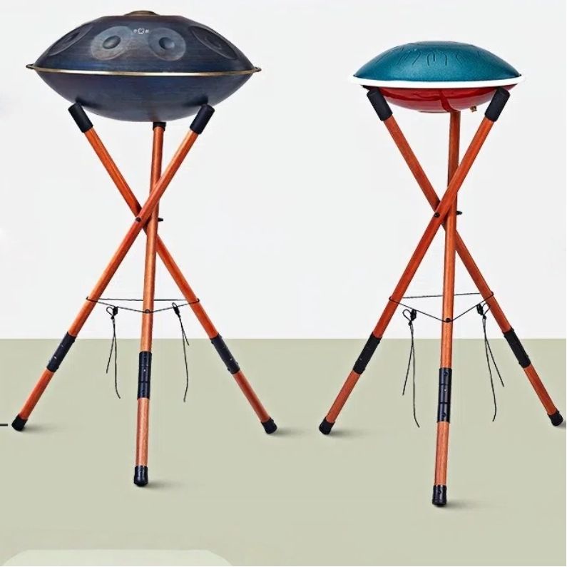 A picture of the MoralGain® wooden handpan stand with a handpan on it, showcasing the stand's overall appearance and adjustable height. Suitable for playing both tongue drums and handpans.