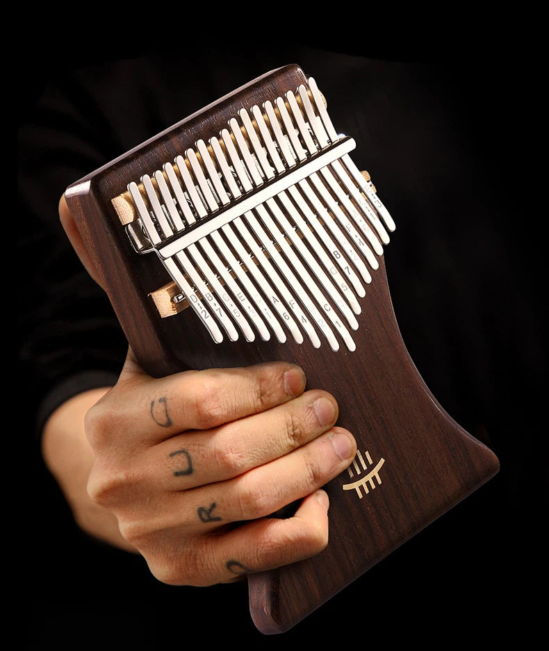A deep-brown solid wood thumb piano resting peacefully among withered autumn leaves, with soft lighting creating a healing and artistic musical vibe.