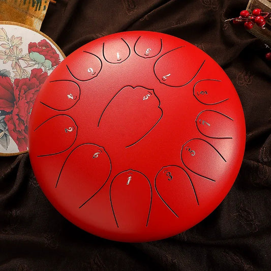 A bold, crimson red MoralGain 12-inch 13-note steel tongue drum, a beautiful and vibrant percussion instrument.