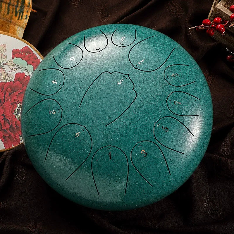 A striking, peacock teal MoralGain 12-inch 13-note steel tongue drum, a vibrant and fun percussion instrument.
