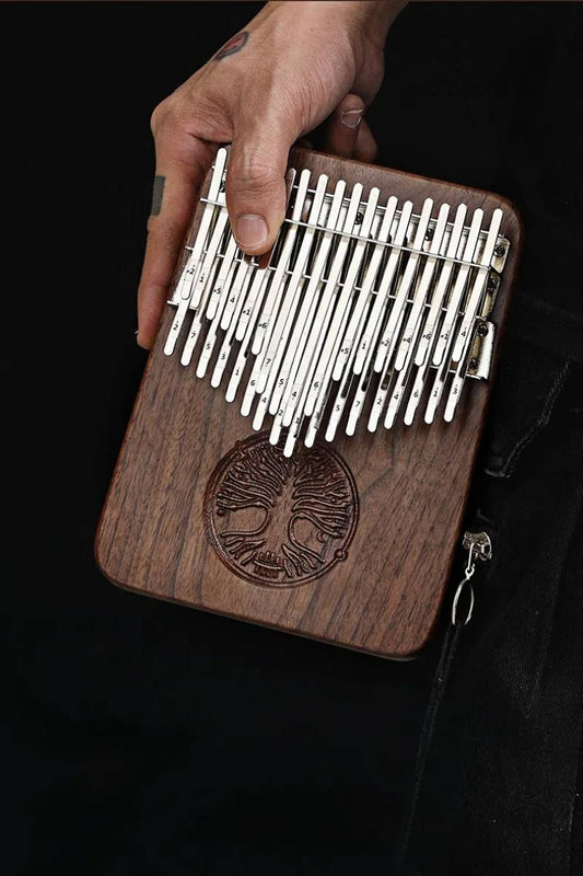 A close-up of a professional musician's hands holding the MoralGain® Legacy kalimba, emphasizing its exquisite craftsmanship and comfortable playability.