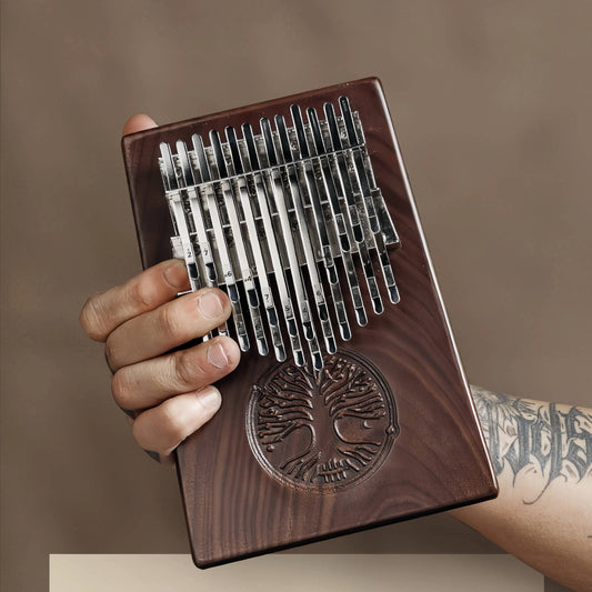 An artistic display of the MoralGain® Legacy kalimba, highlighting the deep color, elegant grain of the solid black walnut, and the integrity of its single-board construction, presented as a precious work of art.