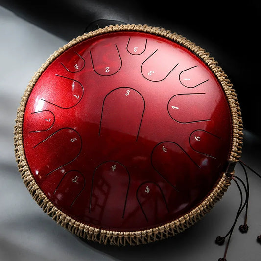 A vibrant Crimson Glow MoralGain Master 14-inch 15-note titanium gold steel tongue drum. Its rich color matches the deep, professional tones it produces.