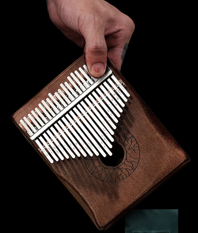A professional wooden kalimba (finger piano) displayed on a rustic surface, showcasing the arrangement of metal tines and unique wood grain design.